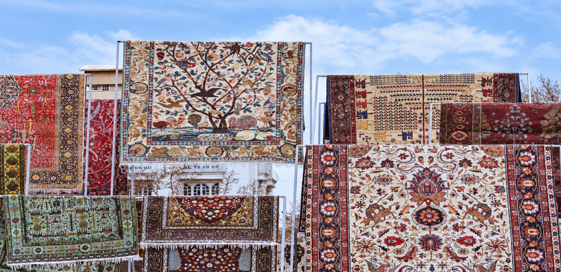 Detailed patterned rugs on display outdoors